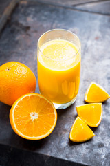 Fresh squeezed orange juice on the rustic background. Selective focus. Shallow depth of field. 