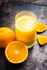 Fresh squeezed orange juice on the rustic background. Selective focus. Shallow depth of field. 