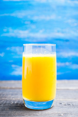 Fresh squeezed orange juice on the rustic background. Selective focus. Shallow depth of field. 