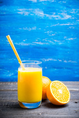 Fresh squeezed orange juice on the rustic background. Selective focus. Shallow depth of field. 