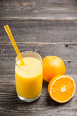 Fresh squeezed orange juice on the rustic background. Selective focus. Shallow depth of field. 