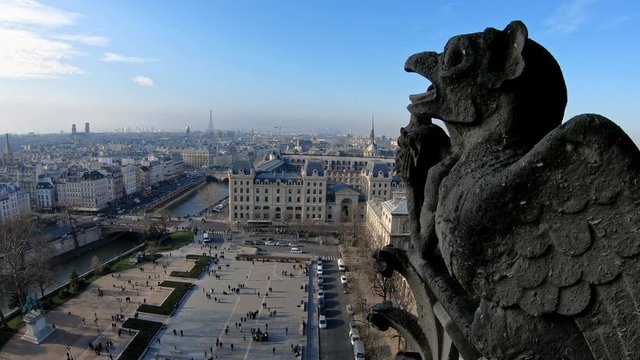 4K, Famous gargoyle statue in Notre Dame Cathedral with city of Paris background. Stone chimera watch over Paris, France. Famous touristic places and popular travel destinations of Europe-Dan