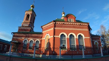 red brick church under the clear sky on a summer day