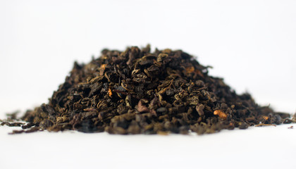 Dry tea leaves. White background. Selective focus.