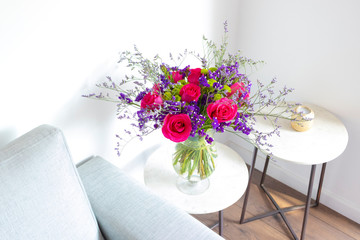 Floral arrangement  of roses and limoniums decorating the living room of the house