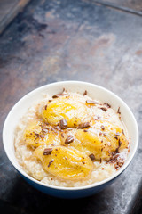 Oatmeal with roasted bananas and chocolate. Selective focus. Shallow depth of field.