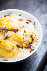 Oatmeal with roasted bananas and chocolate. Selective focus. Shallow depth of field.