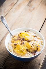 Oatmeal with roasted bananas and chocolate. Selective focus. Shallow depth of field.