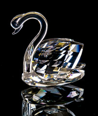 Swan figurine made of glass on a black background