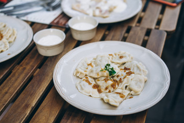 Dumplings with bacon and herbs on a plate