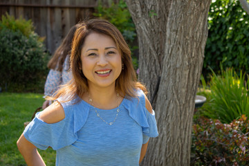 Latina Mother Smiling in Back Yard