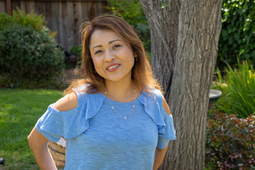 Fototapeta premium Latina Mother Smiling in Back Yard