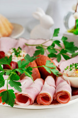 Plate with sliced ham and stuffed eggs.