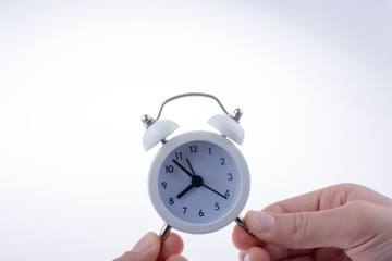 Alarm clock in hand