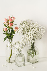 Fototapeta premium Romantic elegant wedding flowers arrangement on table wall background