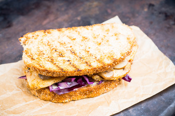 Freshly cooked sandwiches with roasted chicken, purple cabbage and mushrooms. Selective focus. Shallow depth of field.