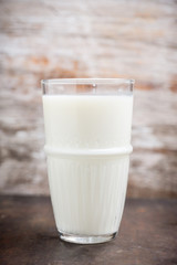 Glass of cold milk on the rustic background. Selective focus. Shallow depth of field.