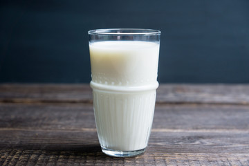 Glass of cold milk on the rustic background. Selective focus. Shallow depth of field.