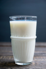 Glass of cold milk on the rustic background. Selective focus. Shallow depth of field.