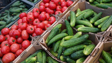 Fresh vegetables cucumbers, tomatoes for sale on farmers market . healthy food in store .
