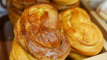 Buns from the oven. Conveyor with fresh bread. White bread in the oven. Hot buns. Confectionery