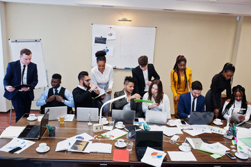 Multiracial young creative people in modern office. Group of young business people are working together with laptop, tablet. Successful freelancers team in coworking.