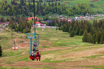 Mountain lift carries people into the valley to the village and the foot of the mountain.