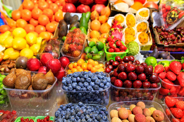 Blueberries, snake fruits, cherries, lime, pomegranates, strawberries, plums, lemon, avocados, mangoes are on the market for sale.