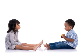two toddler face to face sitting on white floor isolated