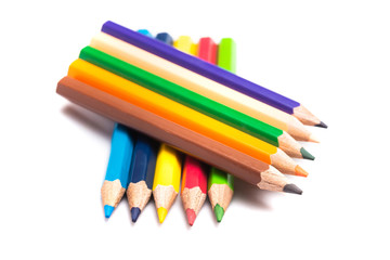 Naklejka premium Colored pencils background with a variety of colors. Many different color pencils on white background. Colored Pencils for School or Professional Use.