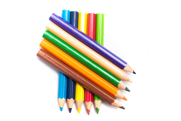 Colored pencils background with a variety of colors. Many different color pencils on white background. Colored Pencils for School or Professional Use.
