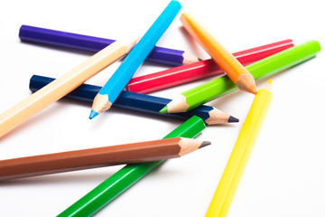 Colored pencils background with a variety of colors. Many different color pencils on white background. Colored Pencils for School or Professional Use.