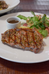 Barbecue Beef Steaks medium rare with grilled potaoes and vegetables.