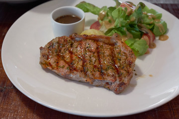 Barbecue Beef Steaks medium rare with grilled potaoes and vegetables.