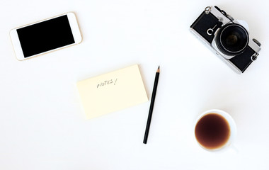 White office photography desk table with laptop, tablet, camera and glass. Top view with copy space