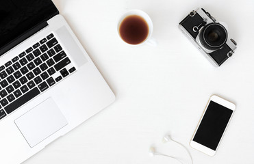 office stuff with tablet, laptop ,smartphone and coffee cup notepad top view shot.