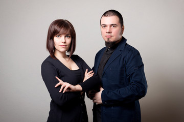 Business portrait of a woman and a man with a beard on a white background.