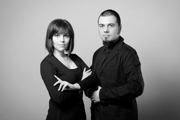 Business portrait of a woman and a man with a beard on a white background. Black and white image.
