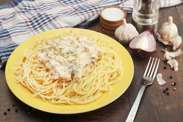 A plate with pasta with salmon