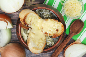 A ceramic pot with French onion soup