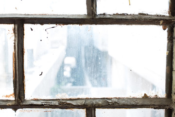 Window of an old house inside view rusted and damaged