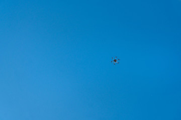 Fototapeta na wymiar Black hexacopter octocopter is flying in sky