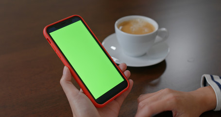Woman use of mobile phone with green screen