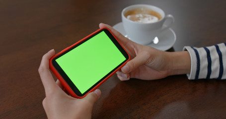 Woman use of mobile phone with green screen