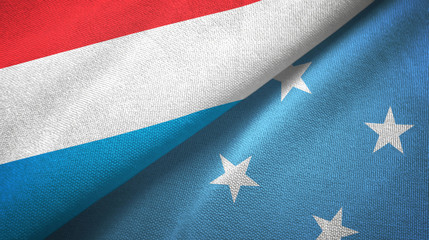 Fototapeta premium Luxembourg and Micronesia two flags textile cloth, fabric texture