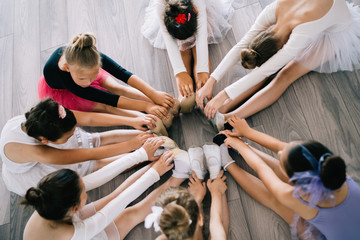 Fototapeta na wymiar Little ballerinas in ballet studio. Group of happy girls exercising together