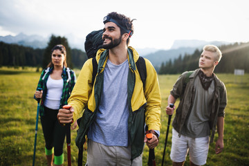 Group of hikers walking on a mountain and smiling