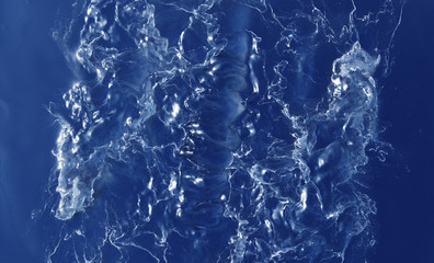 Many White Waves Splashs and Swirls in a blue Liquid