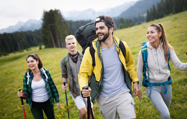 Hiking with friends is so fun. Group of young people with backpacks walking together