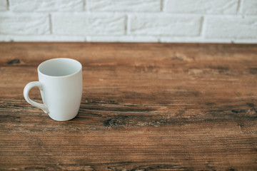 White cup on a wooden table
